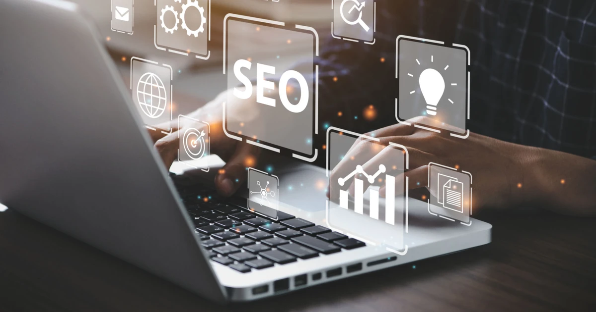 A person analyzing SEO performance on a laptop, surrounded by icons representing search optimization, analytics, and growth